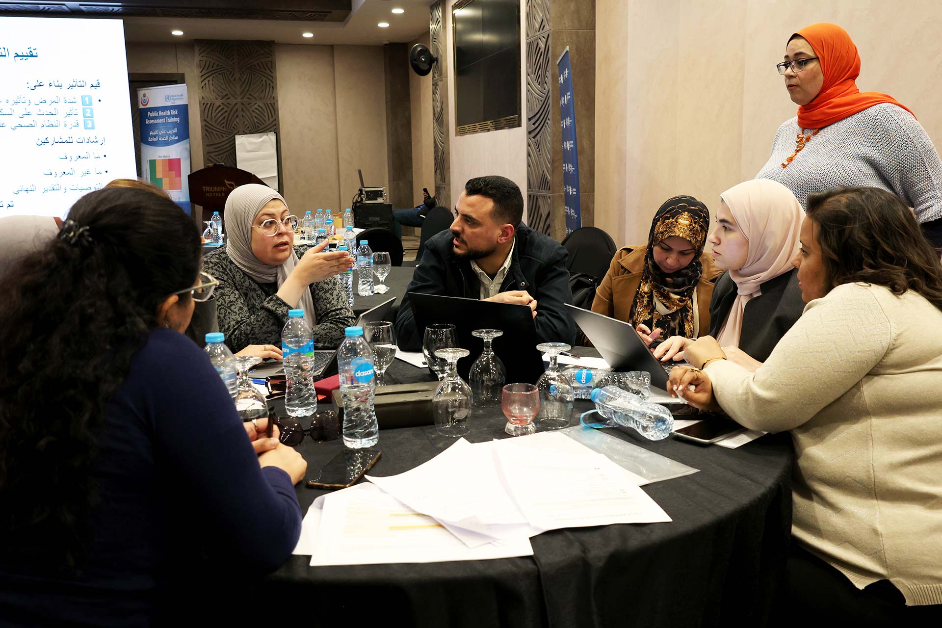 Participants – together with a WHO expert – engage in discussion during a simulation exercise. Photo credit: WHO Egypt
