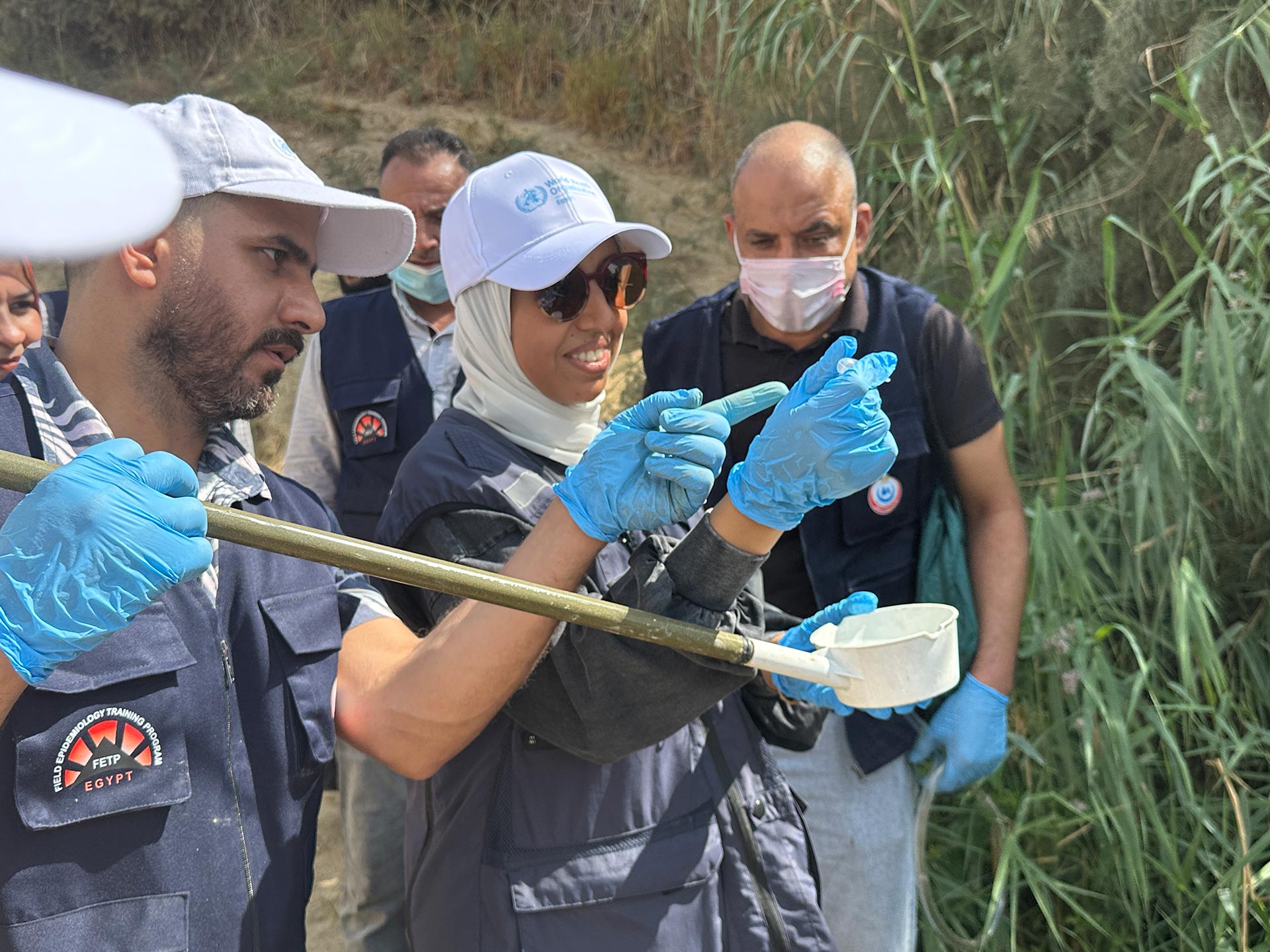 Trainees engaging in hands-on fieldwork activities in vector control, accompanied by a WHO technical officer. Photo credit WHO Egypt