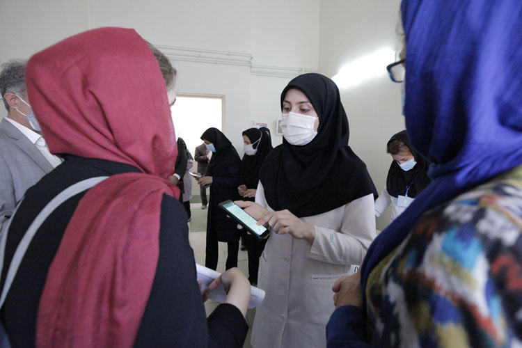 A community health care worker (Moragheb-e-Salamat) at a primary health care facility in Sahand talks to the WHO assessment team about Islamic Republic of Iran’s social media campaigns to raise the public’s awareness about COVID-19 prevention and control measures