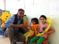 WHO staff member with children in a Jordanian hospital