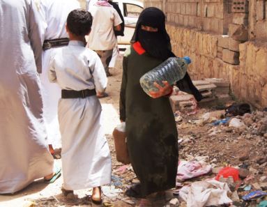 Young girl in Yemen holds empty water bottle