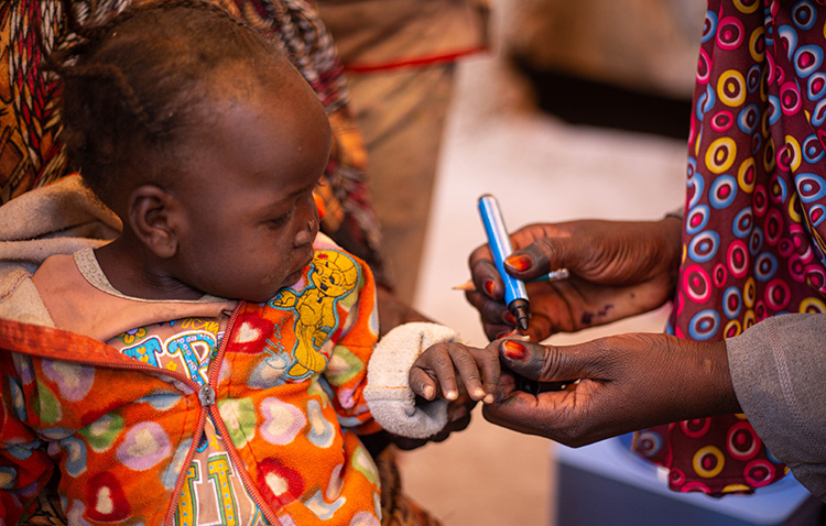 A vaccinator marks the little finger of a child who has been vaccinated, Sudan, November 2020. Photo credit: WHO/WHO Sudan