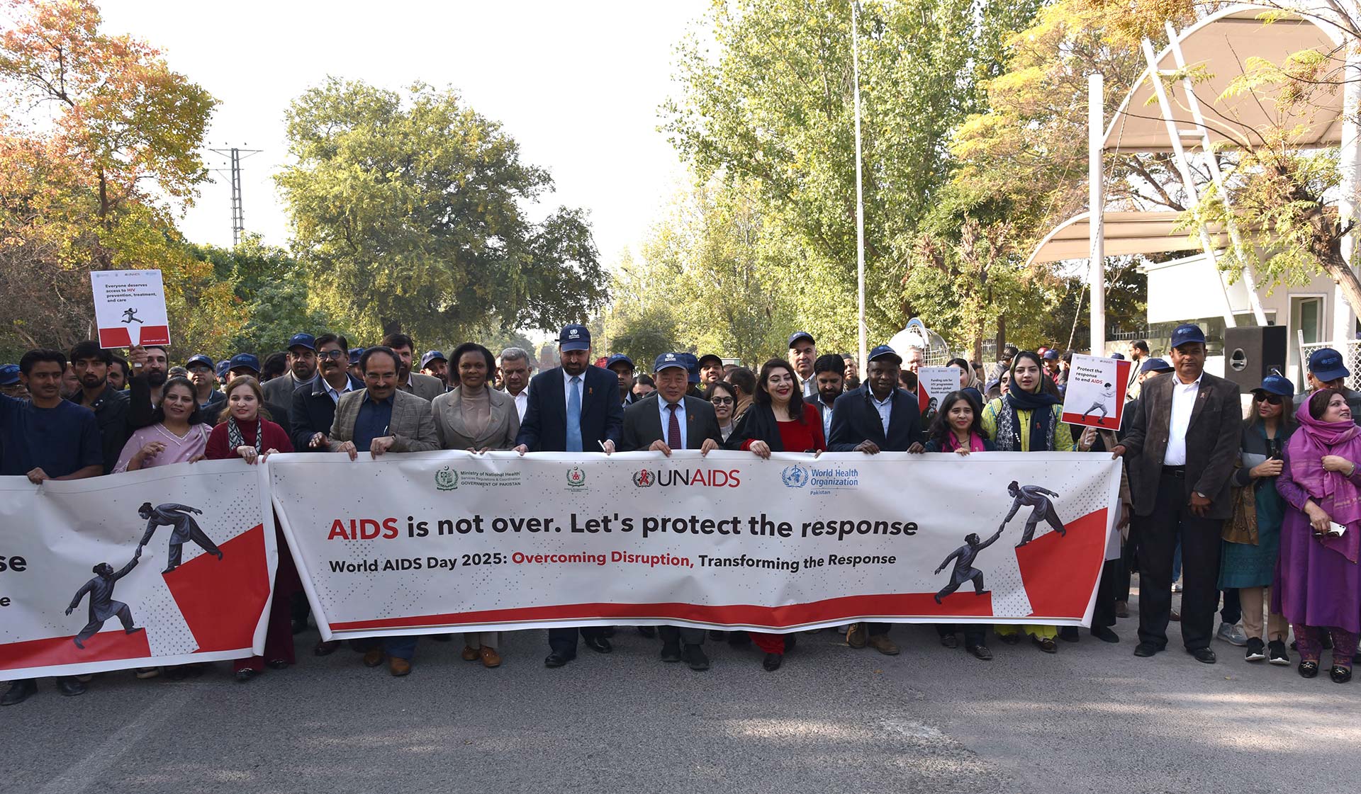 WHO  Representative in Pakistan Dr Luo Dapeng, Pakistan’s Health Director General Dr Ayesha Majeed Isani, and UNAIDS Director in Pakistan, Trouble Chikoko, lead an awareness walk to mark World AIDS Day. Photo credit: Hamid Inam/WHO Pakistan.