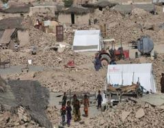 Families erect tents amid the chaos as houses are damaged and destroyed as a result of the earthquake in Awaran