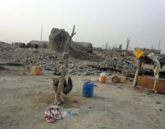 A scene of devastation following the earthquake with houses destroyed and people living outdoors