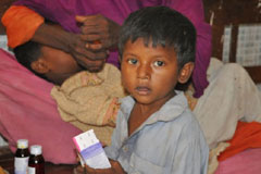 A child receives free medicine donated by the WHO Regional Office for the Eastern Mediterranean in a hospital in Thatta, Sindh, following the flood in 2011