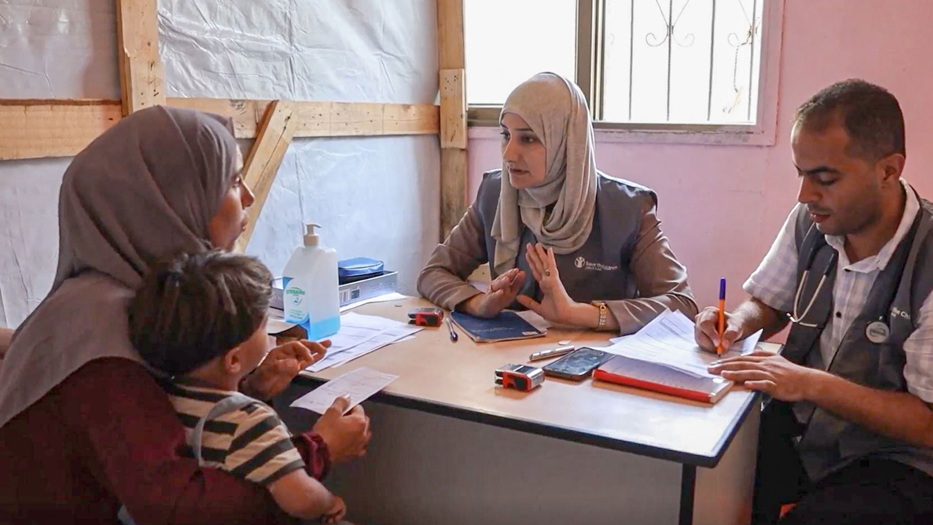 A mother and child receive consultation at primary health care centre in Gaza