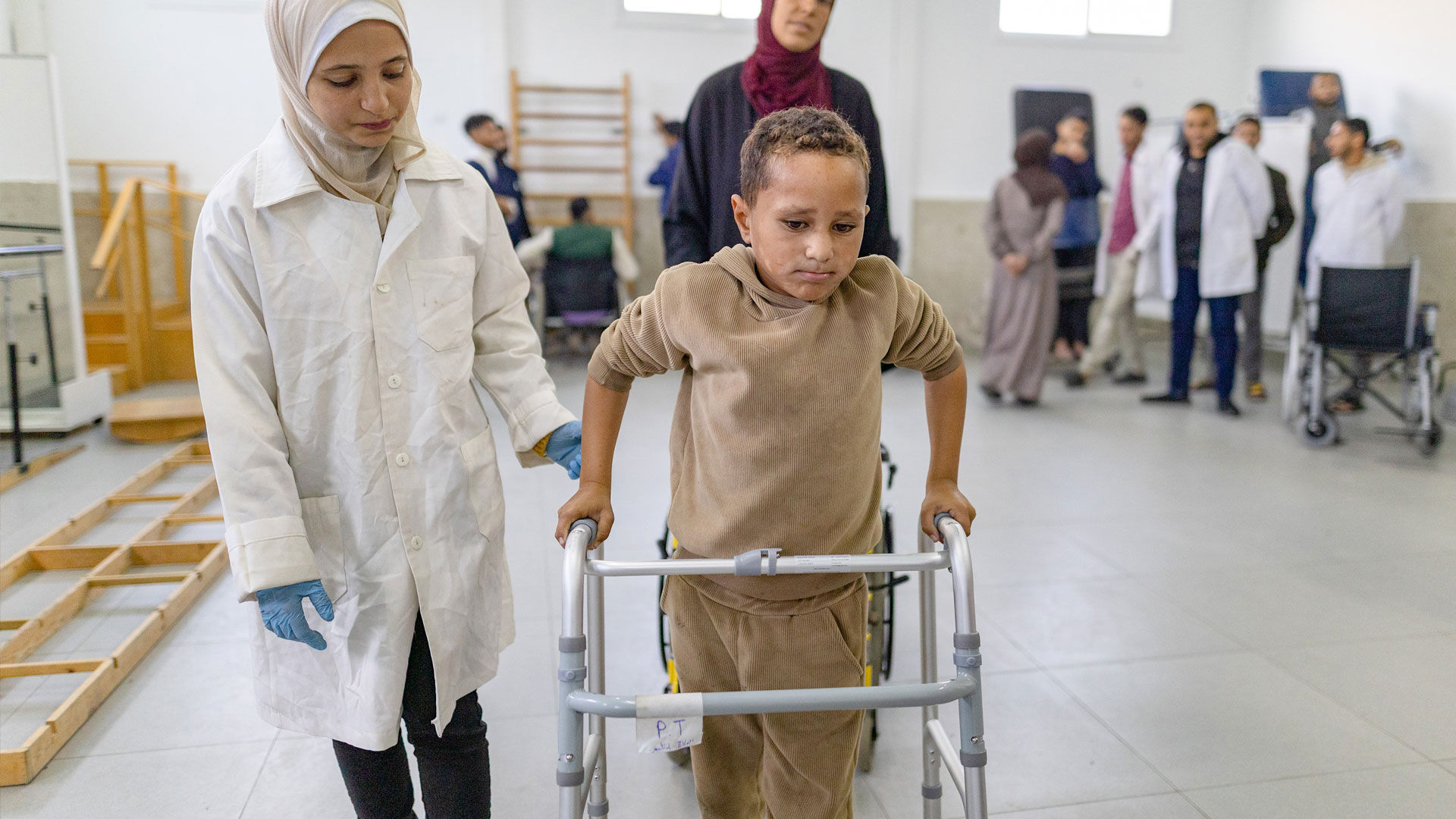 A young patient injured during the conflict in Gaza receives physical rehabilitation at Al-Amal PRCS Rehabilitation Hospital