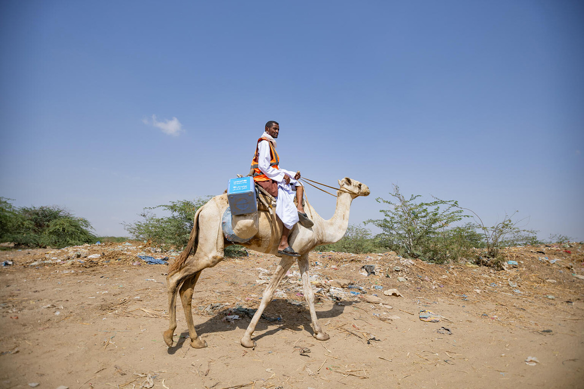 Mahmoud, a vaccinator, and health worker in remote Agig locality, located in Red Sea State, rides on a camel accessing children during the door-to-door polio vaccination campaign in Barqiq valley.  Photo credit: ©UNICEF/UNI563034/Mohamdeen