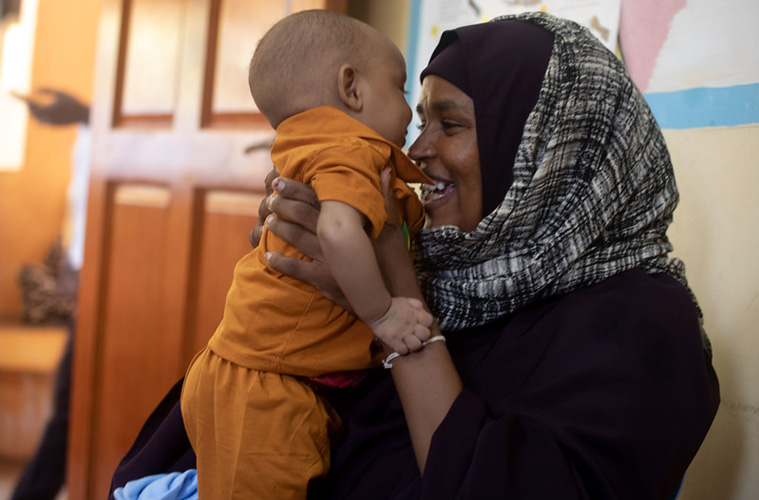 A mother and her child at a Public Health Centre of one of the drought-affected districts in Kismayo, Somalia. Photo credit: WHO Somalia/I. Taxta