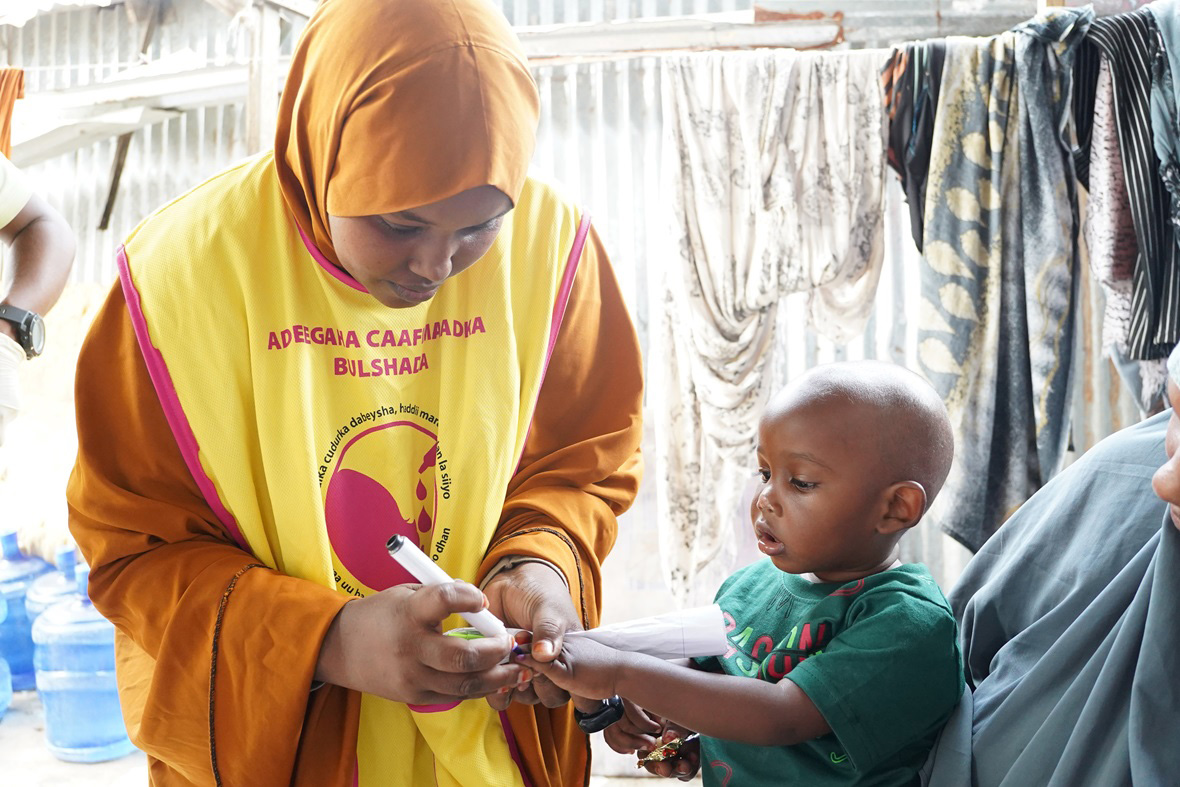 Layla Omar Mohamed, a polio vaccinator in Hodan district of the Banadir region, administers polio vaccines during the National Immunization Days (NID) campaign held in June in Banadir, Somalia. Photo credit: Abdirahim Caaylaawe