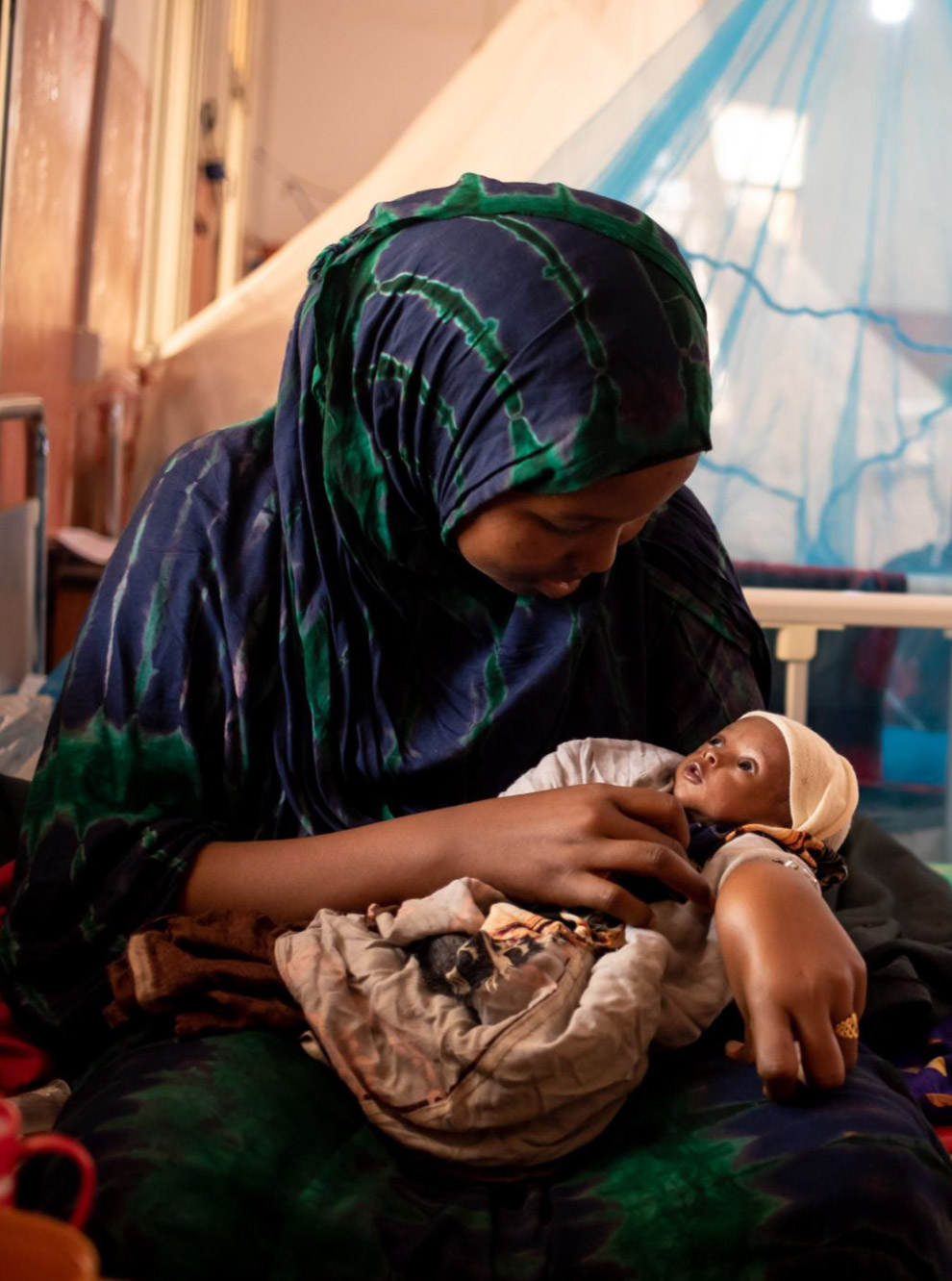 Safia holds her one-year-old daughter Sahra at Bay Regional Hospital in Baidoa, Somalia.Photo credit: WHO / Ismail Taxta