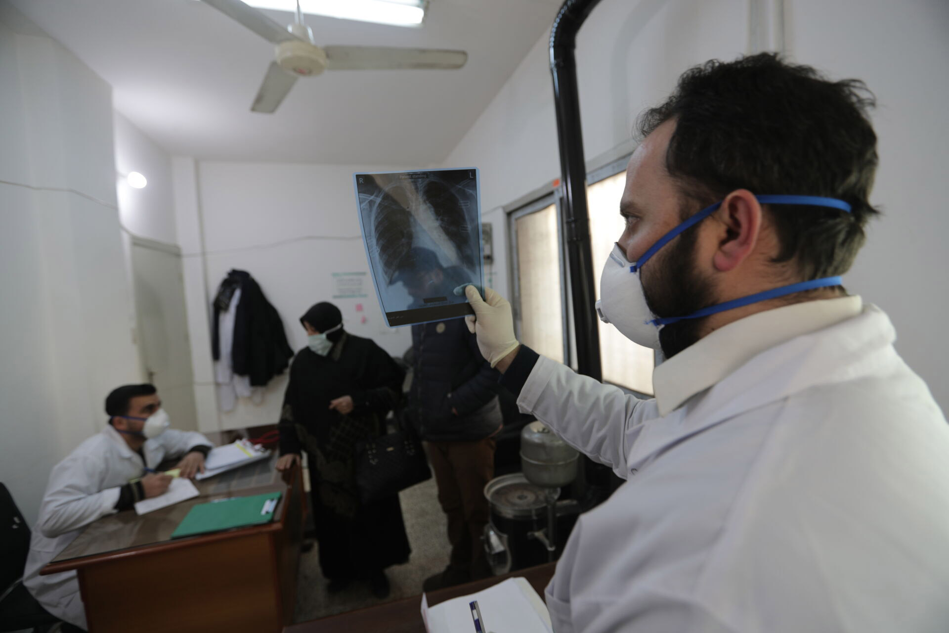 Doctor checking an x-ray of a TB patient