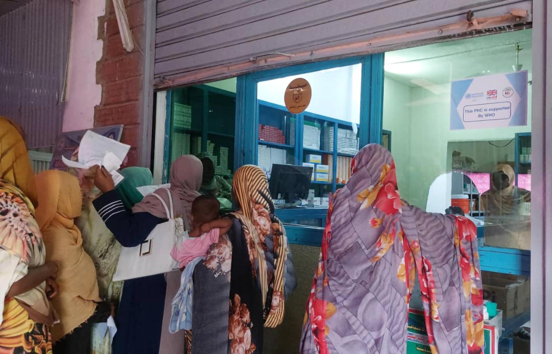 Patients queuing at a pharmacy in a WHO-supported primary health care centre