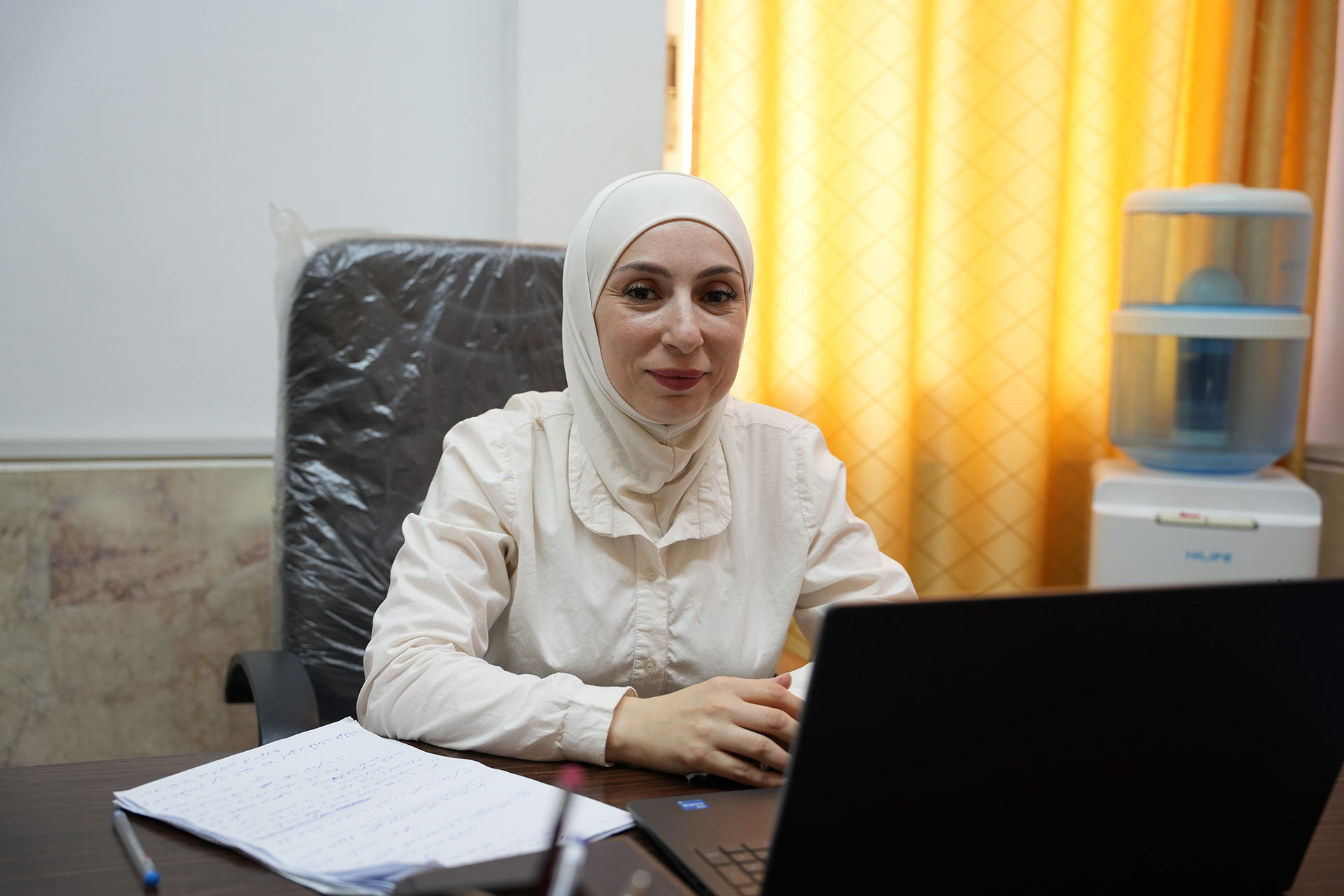 Afraa Mawardi, Head of the Drug Control Unit at the National Hospital in Lattakia, at her office, talks about the issue of antibiotic use. Photo credit: WHO