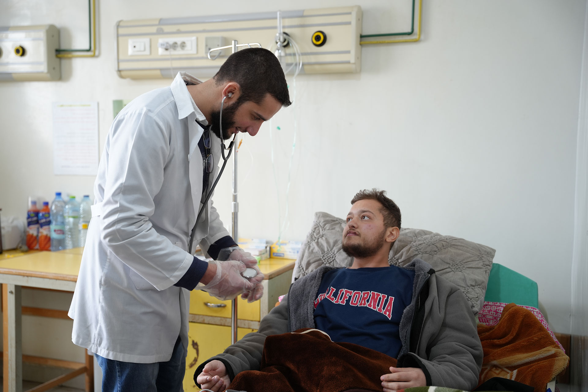 Ahmad with the doctor, checking on his health situation and providing him with the medical treatment needed. Photo credit: WHO