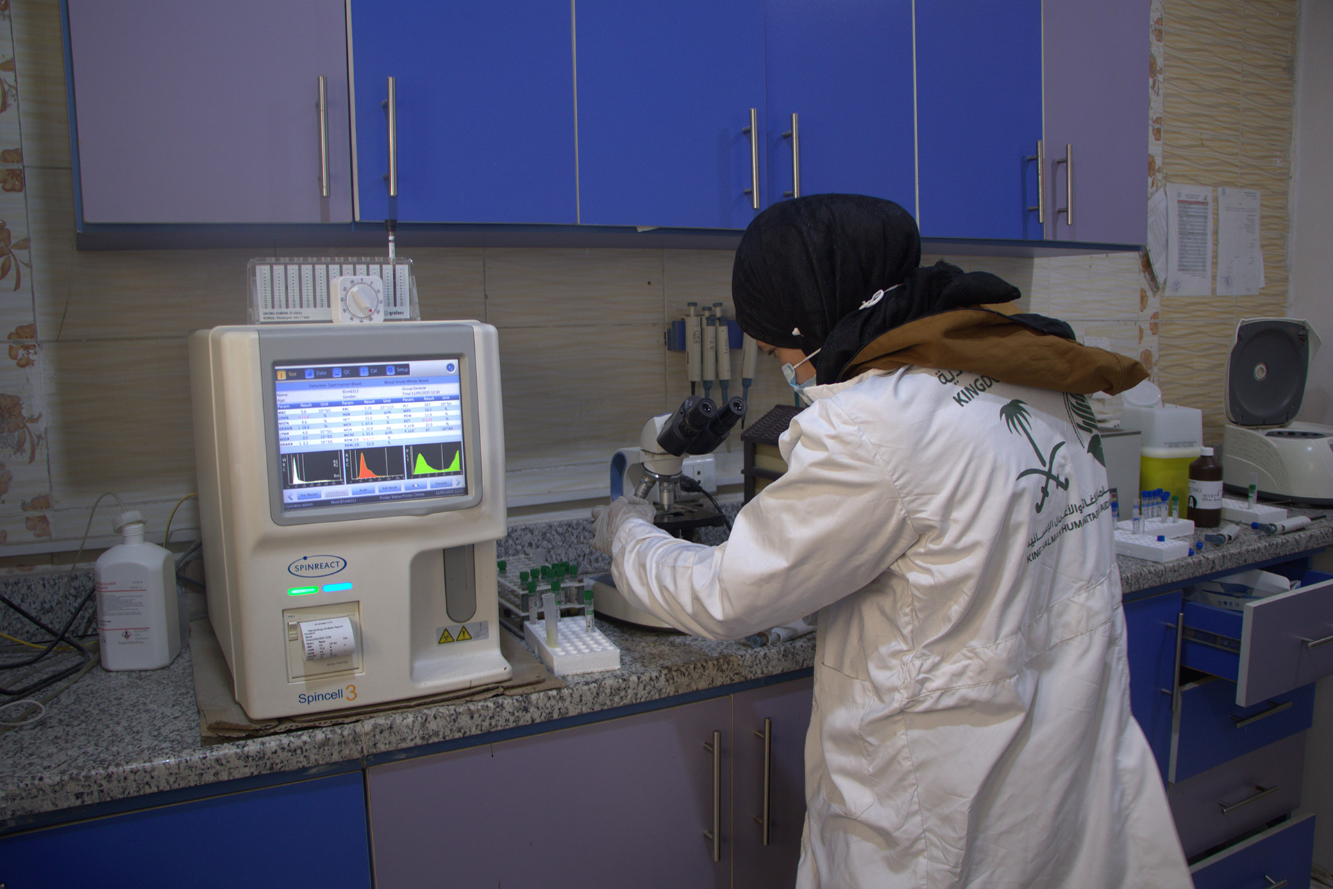 Maryam conducts microscopy work inside the laboratory at Al-Bab Health Centre. Photo credit: WHO