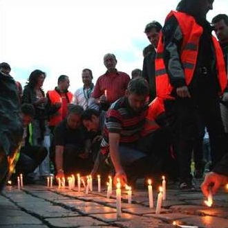 People lighting candles in remembrance of World Day of Remembrance for Road Traffic Victims