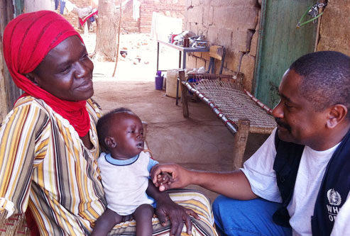 WHO staff speaking to mother and child in South Kordofan